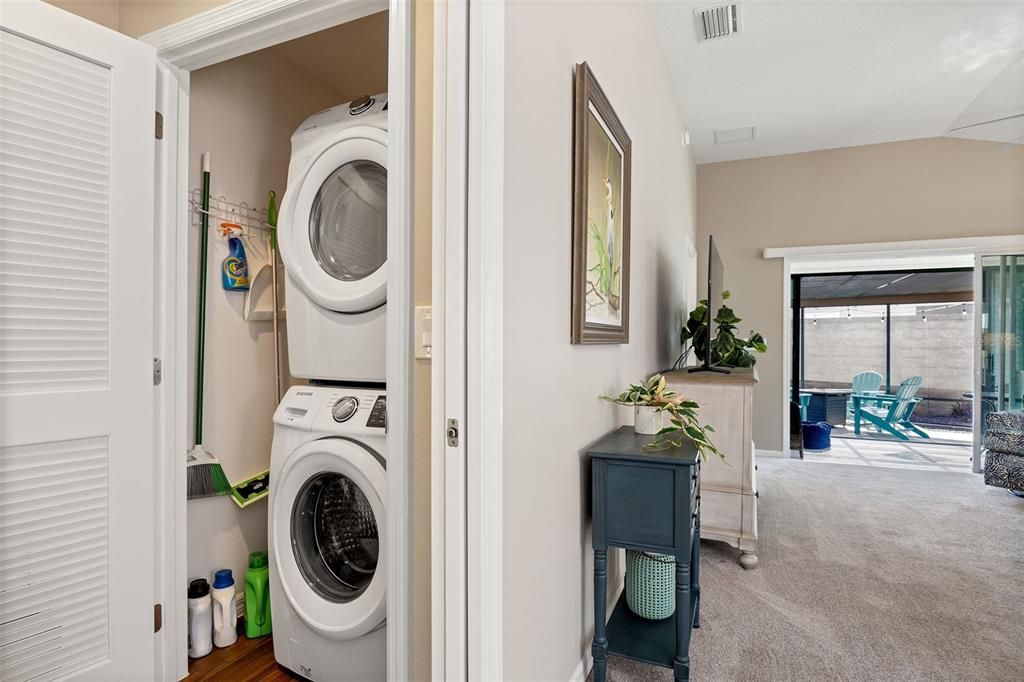 Full-size stacked washer and dryer units discreetly tucked away simplify laundry tasks.
