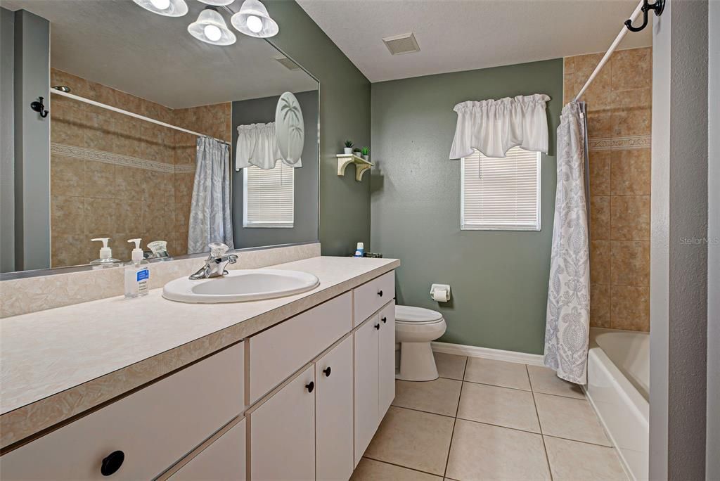 The guest bathroom with tub and shower.