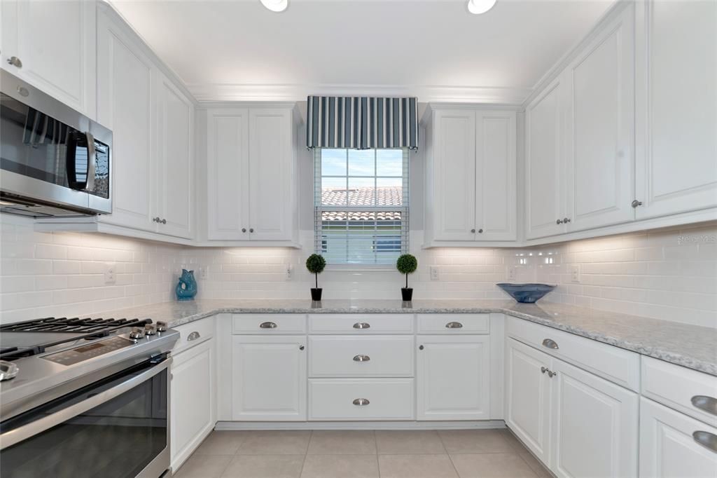 The kitchen has  quartz countertops, 42" cabinets and upgraded appliances.
