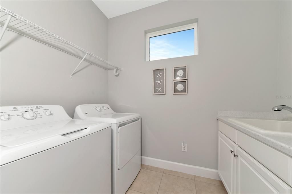 Laundry Room with lower cabinets and a utility sink.