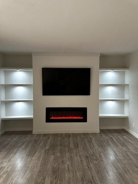Living area with build in shelves and fireplace