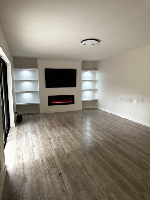 Living area with build in shelves, fireplace , water and scratch resistant laminate