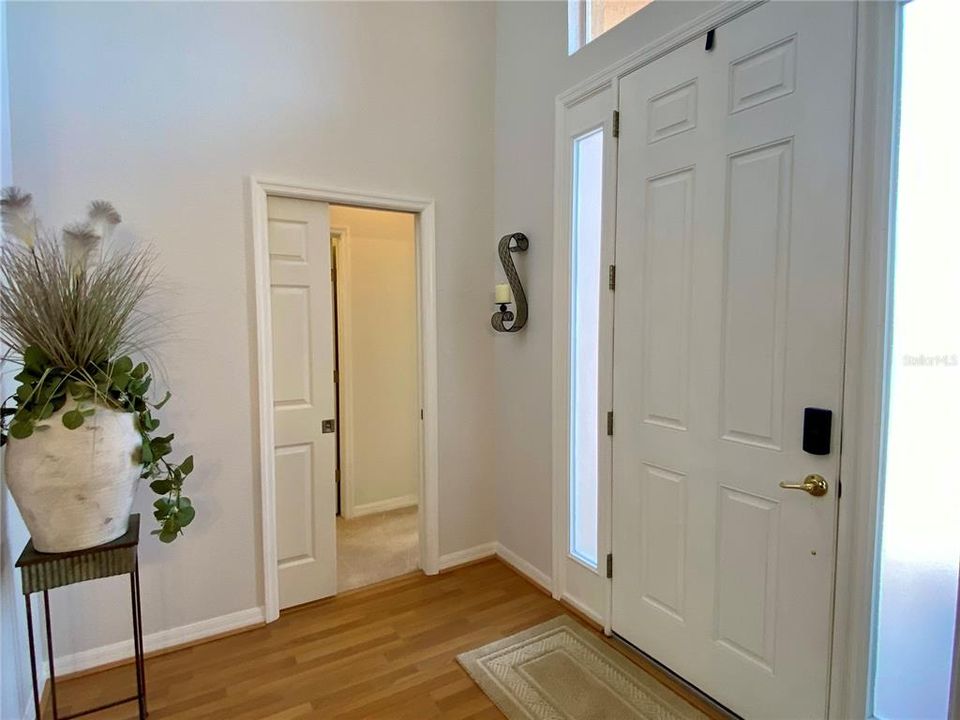 Entryway at front door with pocket door to guest bedroom and bathroom