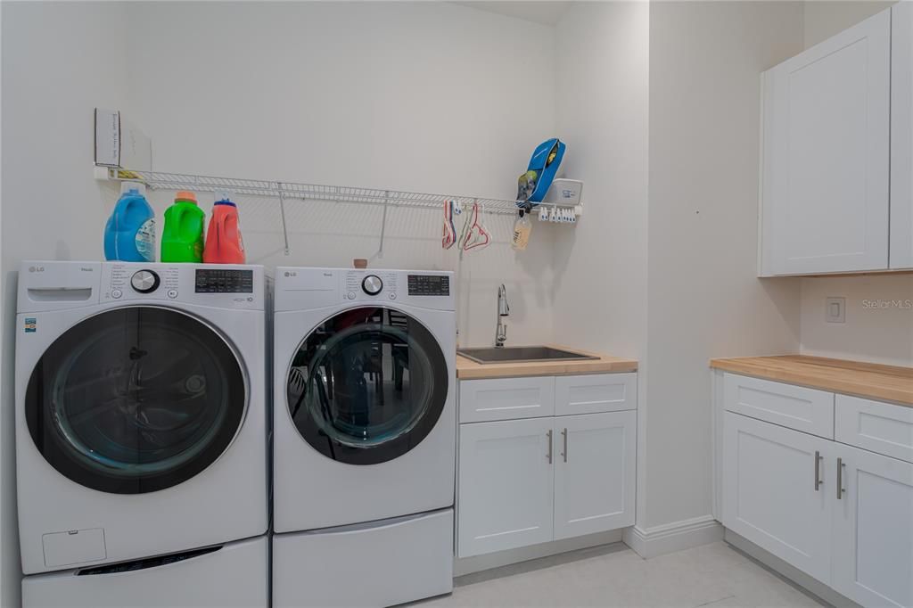 Laundry room with sink, shelf, and cabinets (washer & dryer do not convey)