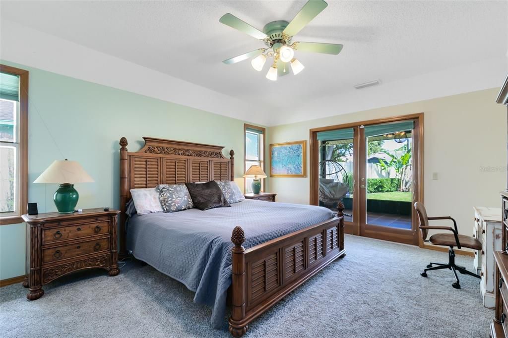 Retreat to the master suite, featuring private French door access to the screened lanai.