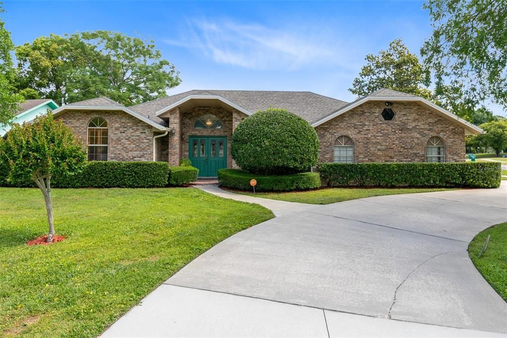 Situated on a picturesque corner lot, this stunning Deltona residence welcomes you with lush landscaping and inviting charm.