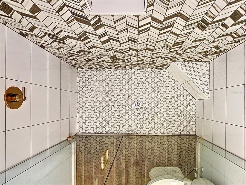 Looking down on the tile floor in the shower.
