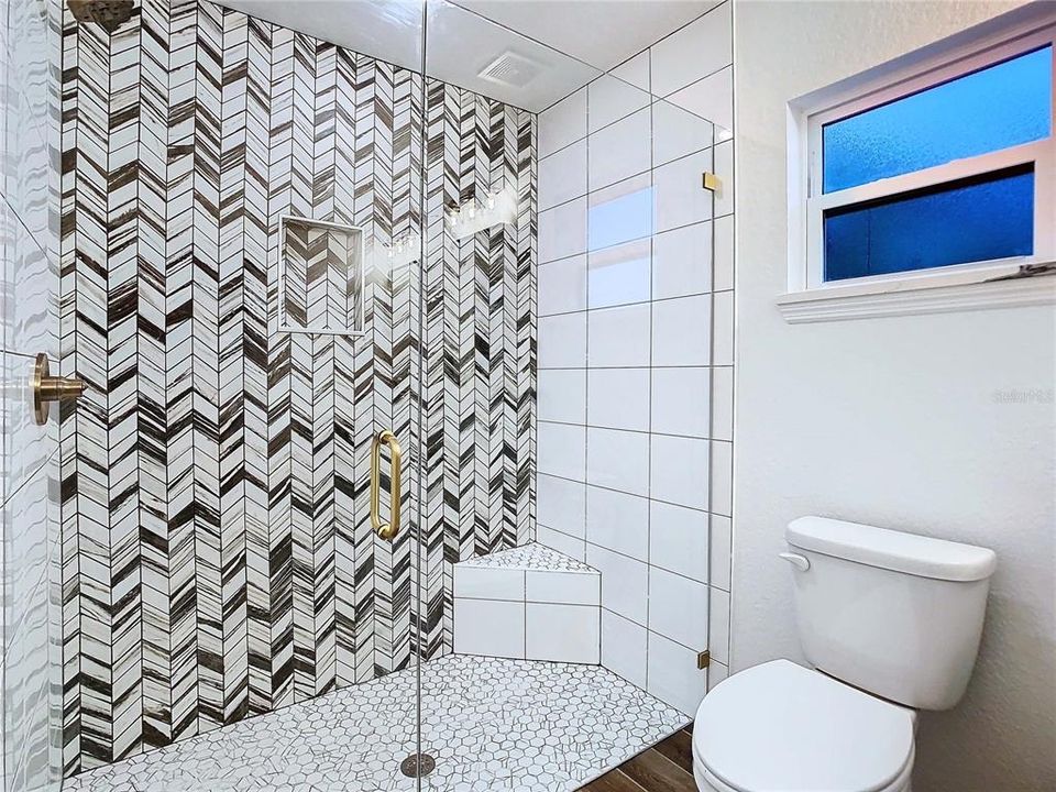 Love the tile work in the bathroom along with shower seat.
