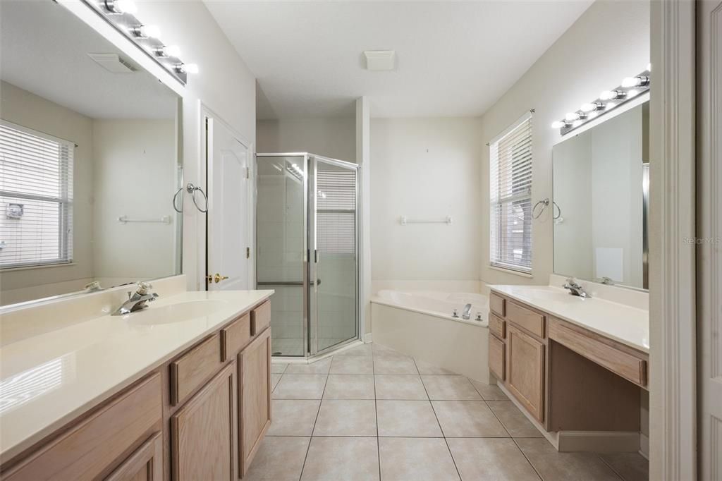 Dual vanities, soaker tub, stand alone shower and water closet.