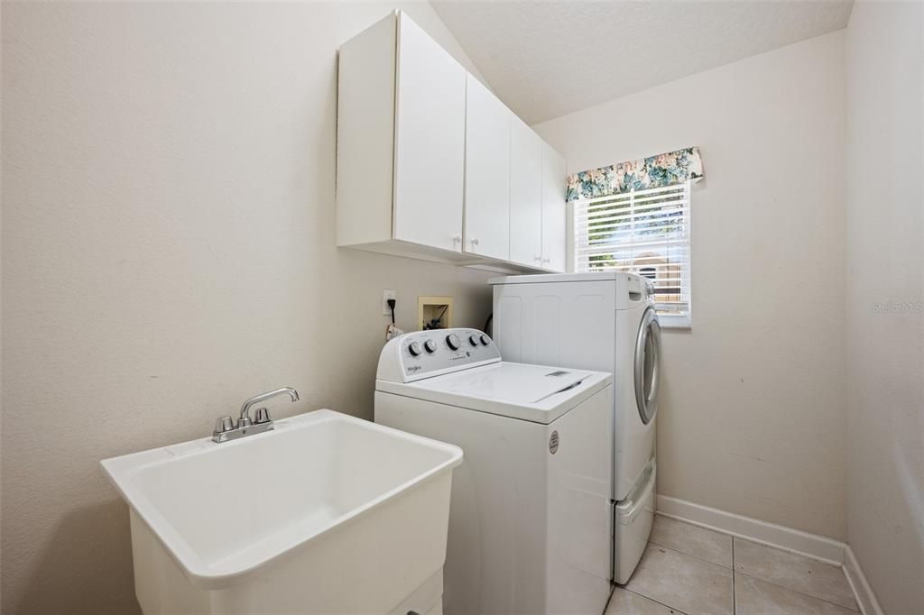 Laundry room with utility sink and storage