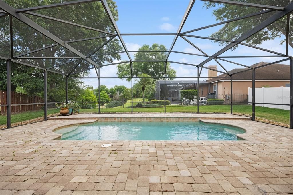 Pool and cage added to the home in 2010 with large brick pavers