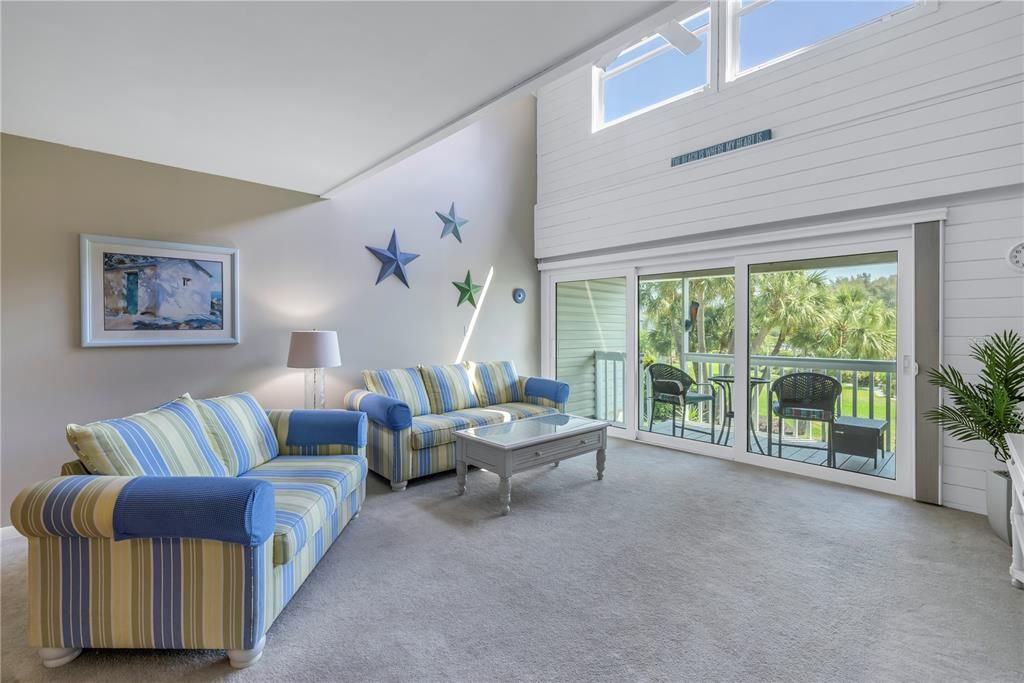 Living Room with hurricane sliding doors leading to a private balcony