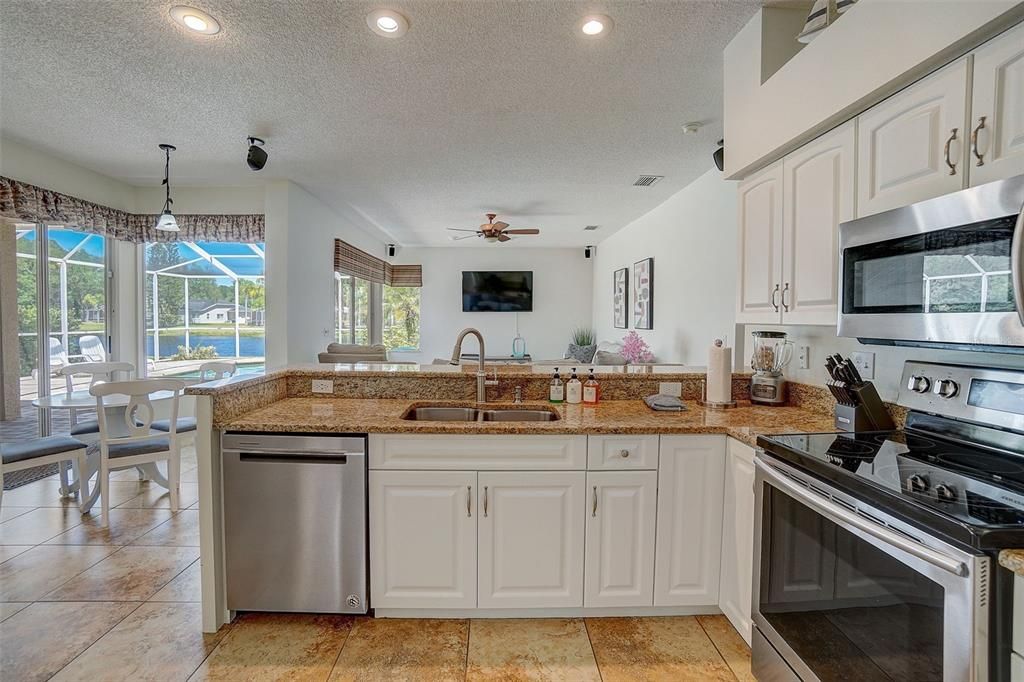Beautiful kitchen flows seamlessly into casual dining area and spacious family room.