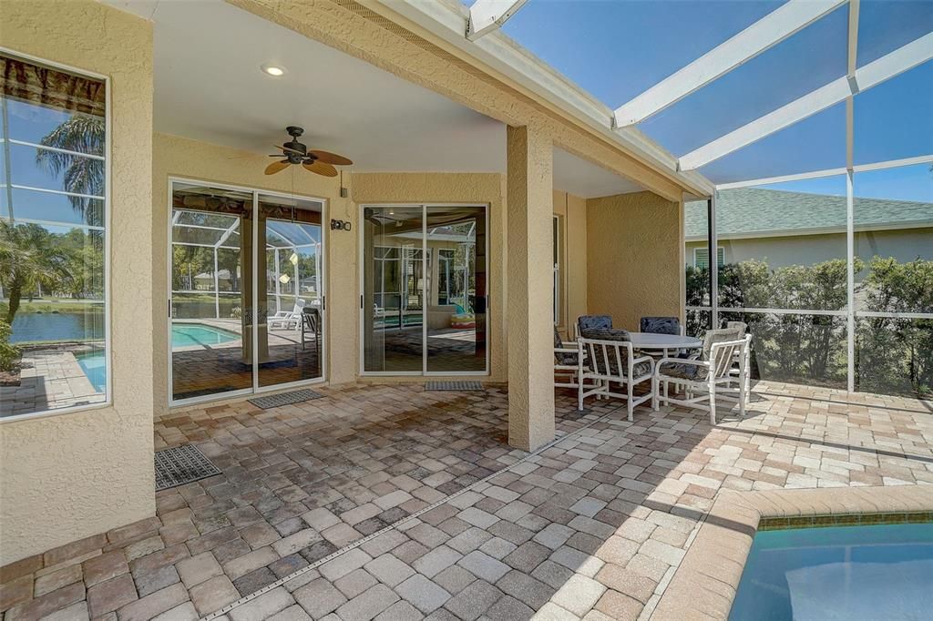 Screened-In Patio with beautiful pavers and covered seating area