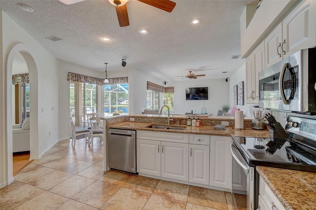 Beautiful kitchen flows seamlessly into casual dining area and spacious family room.