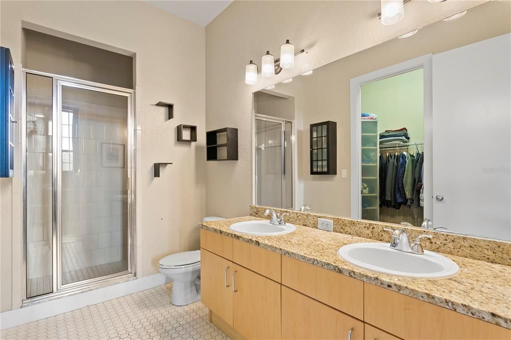 Double vanity sinks within primary bedroom
