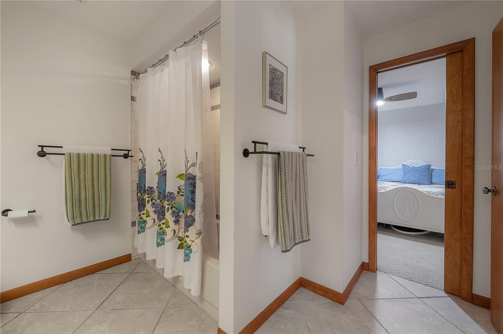 Access the guest bathroom from the hallway or one of the guest bedrooms.