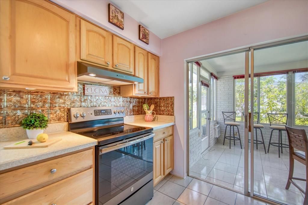 Kitchen opens to sunroom with sliding doors~
