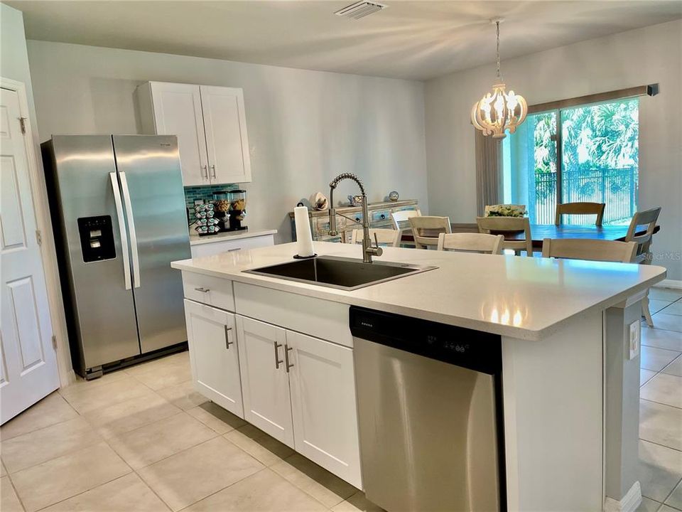 Kitchen has stainless appliances and upgraded large single bowl sink with updated pluming fixtures