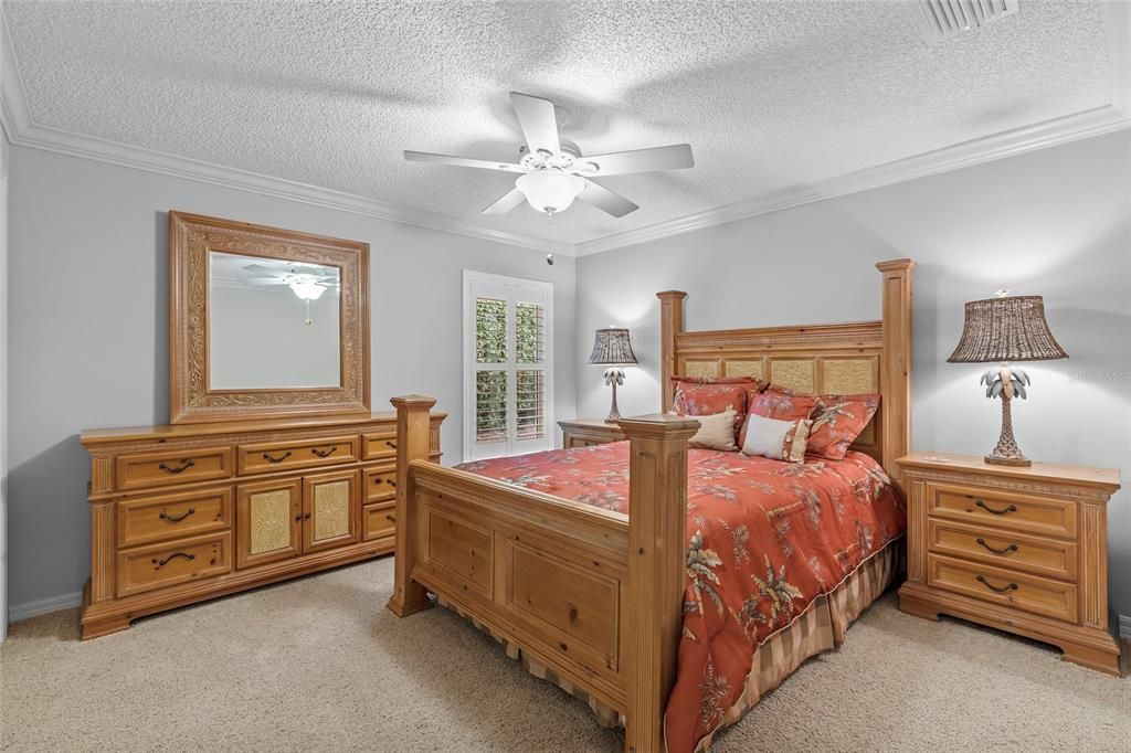 3rd bedroom with crown molding, plush carpet
