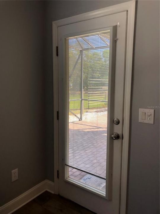 Door that leads into screened patio and fenced in backyard.