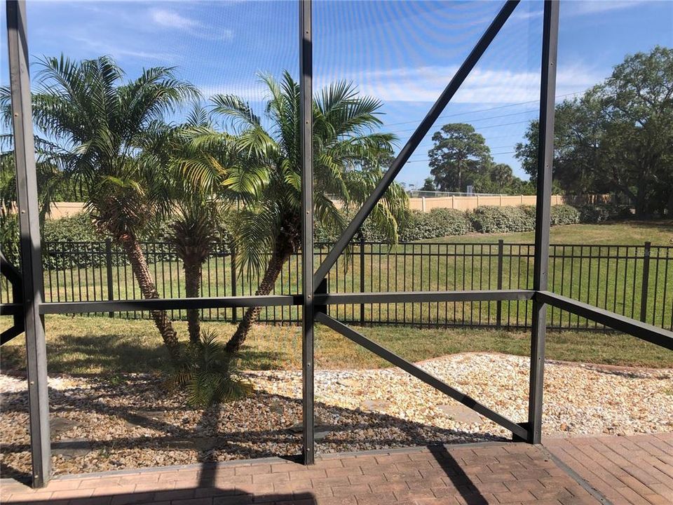 Screened in patio overlooks large fenced in back yard