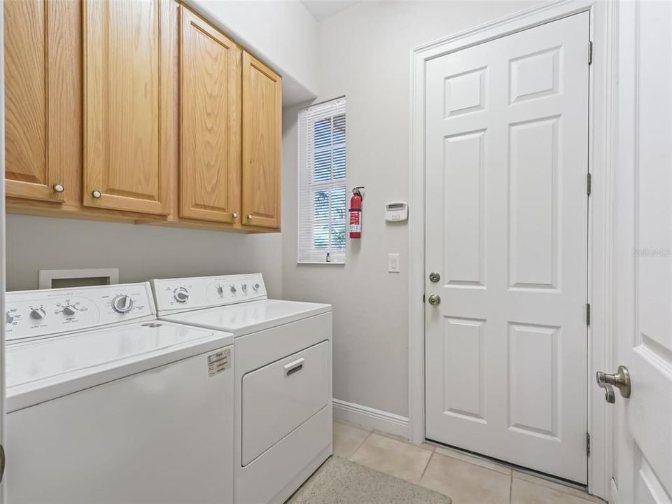 Laundry room with wood cabinets - door to garage