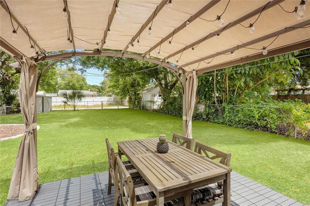 Covered outdoor area in fully fenced backyard