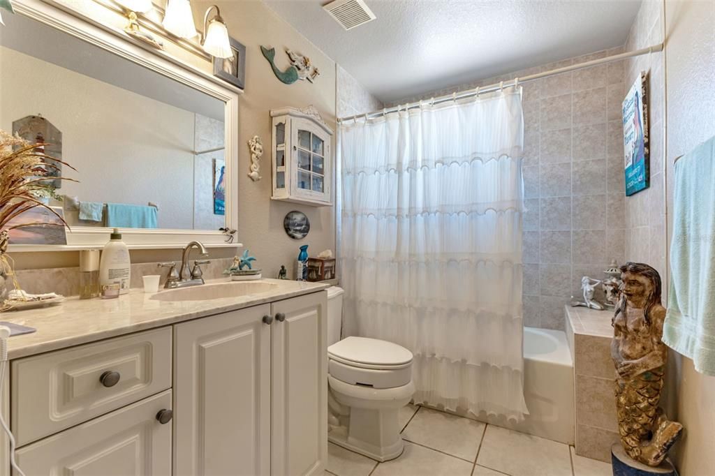 ROOMY GUEST BATHROOM WITH TUB/SHOWER COMBINATION.