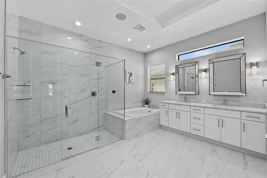 Spacious Bathroom with neutral tile throughout
