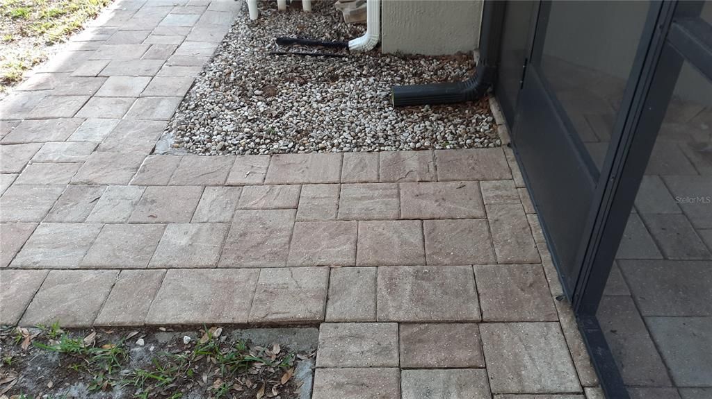 Paved walkways on a side of the house