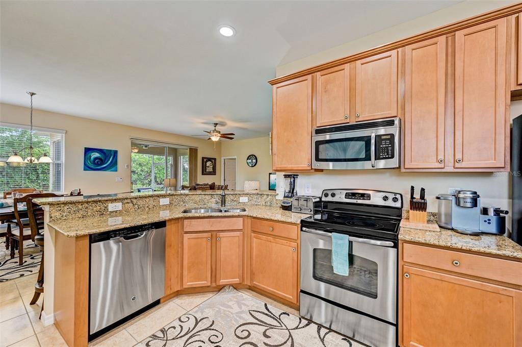 Open Kitchen, all GE Stainless Appliances, Granite Countertops, Dual Sink, 42" Solid Wood Cabinets with soft close feature.