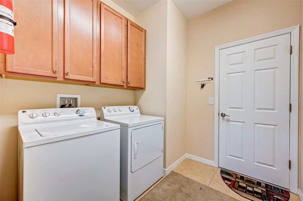 Inside Laundry Room includes Washer and Dryer. Door to the right exits into the two car attached garage.
