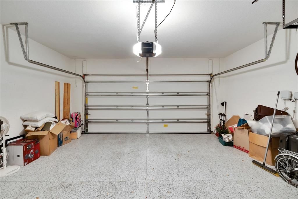 Garage w/ epoxy floor and storage rack to the right