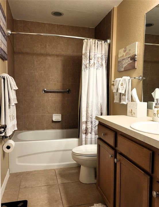 Guest bath with tub/shower combo.