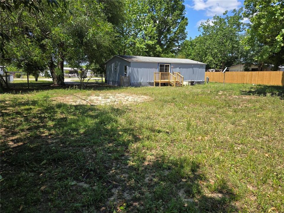Large partially fenced backyard