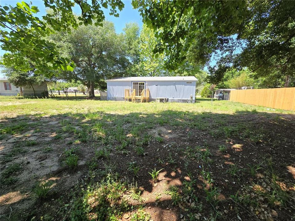 Large partially fenced backyard