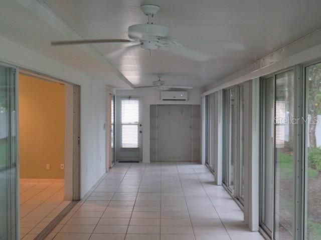 Enclosed and air conditioned Florida room with sliding glass doors