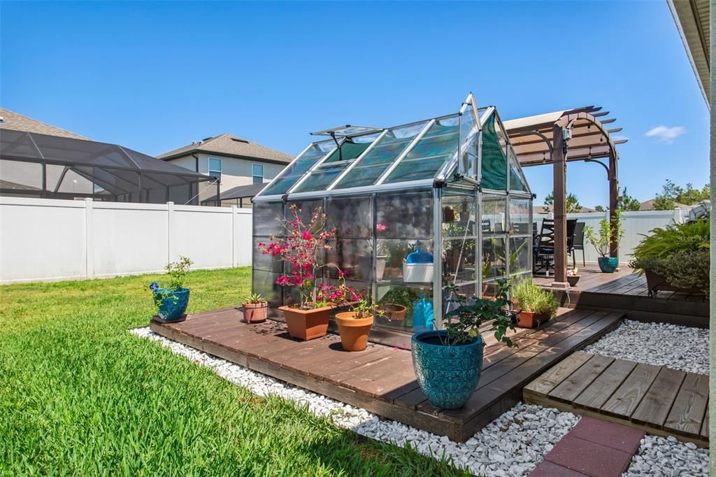 Greenhouse, wooden deck, pergola, & shed all convey with the property!