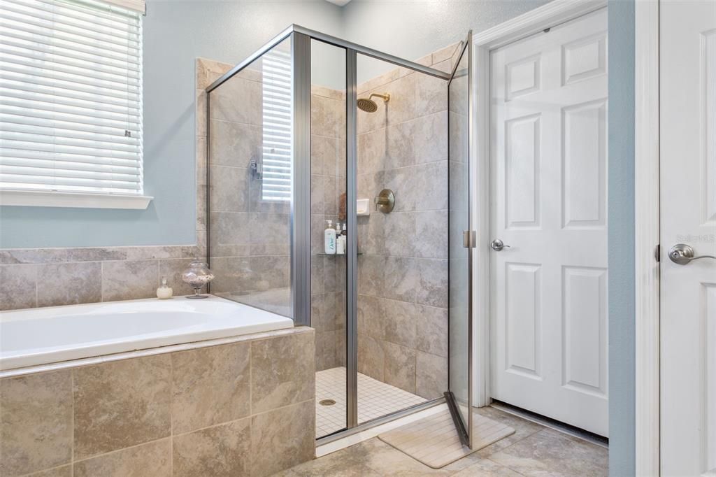 Walk in shower in the primary bathroom with access to the walk in closet.