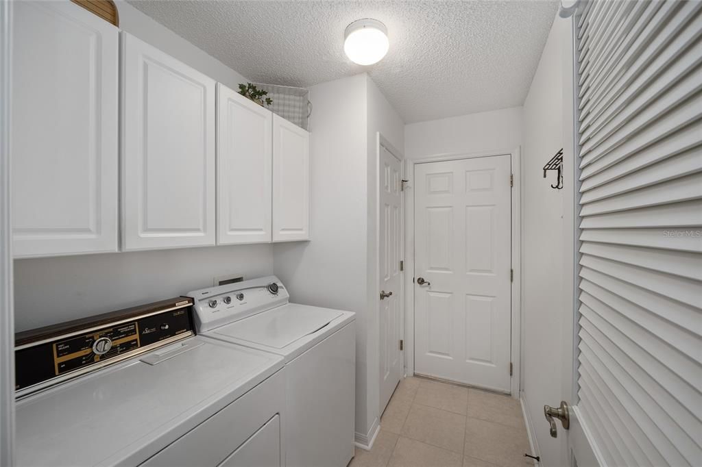 Inside Laundry Room with Pantry Closet