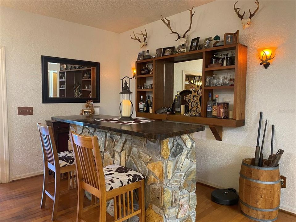 Dining room area has a built in bar with the same type of stone work that is on the fireplace in the living room