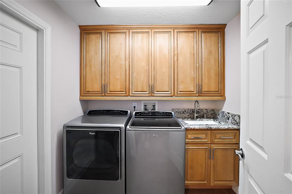 Laundry room w/matching countertops and cabinetry