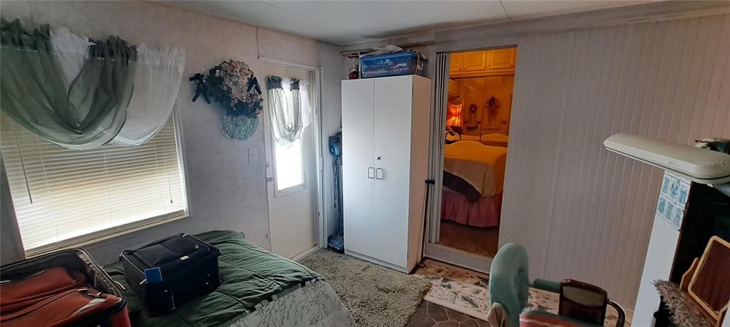 BONUS ROOM LOOKING INT0 PRIMARY BEDROOM WITH EXTERIOR DOOR ON LEFT