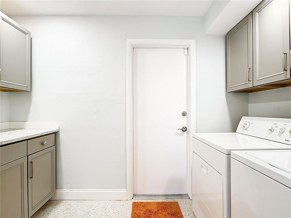 The Laundry Room is conveniently located inside the home and has great additional cupboard space for storage and a wonderful counter for folding clothes.