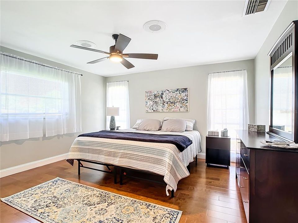 The Primary Bedroom Suite is split from the other 2 Bedrooms for optimal privacy and is furnished with a King sized bed and just look at all the natural light coming in from the 3 windows!!!