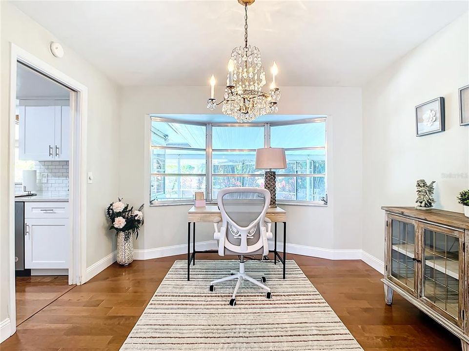 Off of the Great Room & Kitchen, there is a flex space with a large bay window overlooking the pool.   It is currently set up as an Office but could also be an additional dining area or hobby/work out space.