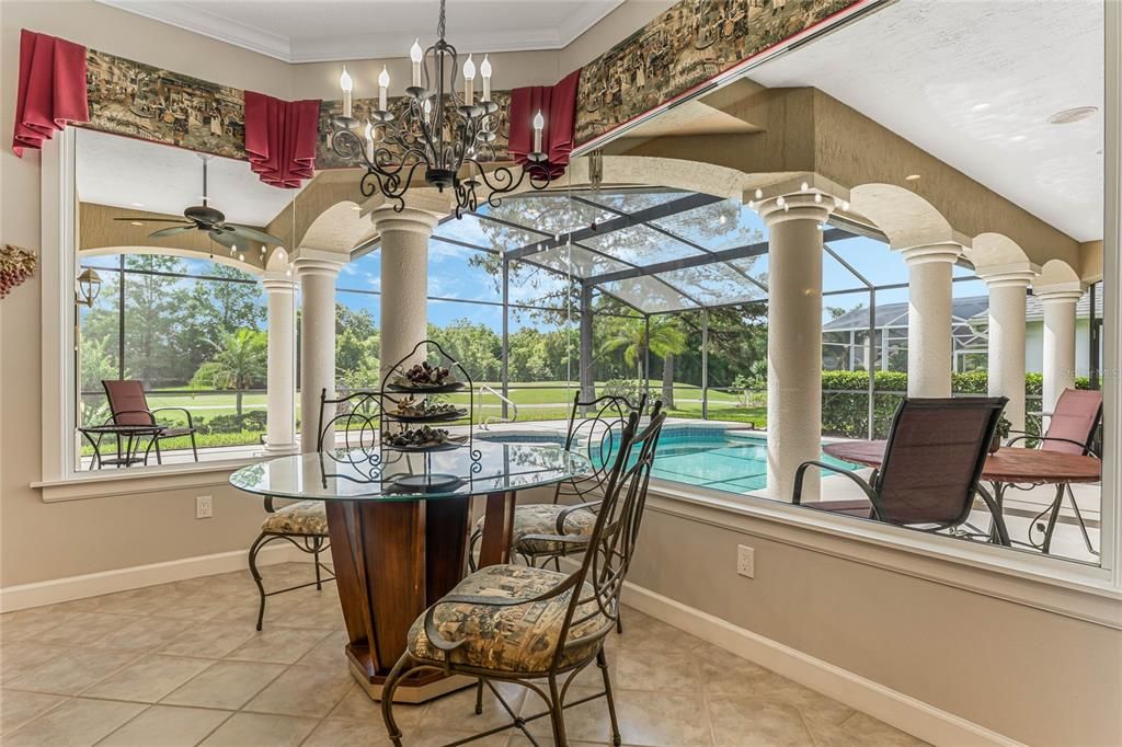 Dinette with Oversized Picture Windows Overlooking Gorgeous Pool and Screened Lanai