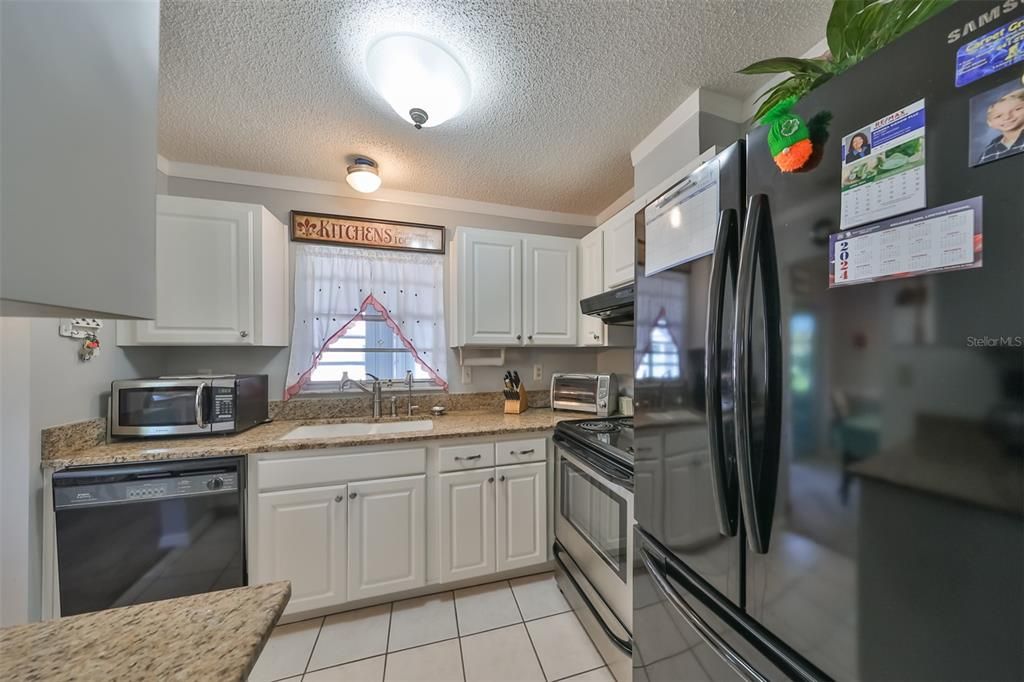 Stainless and black appliances and granit counter tops.