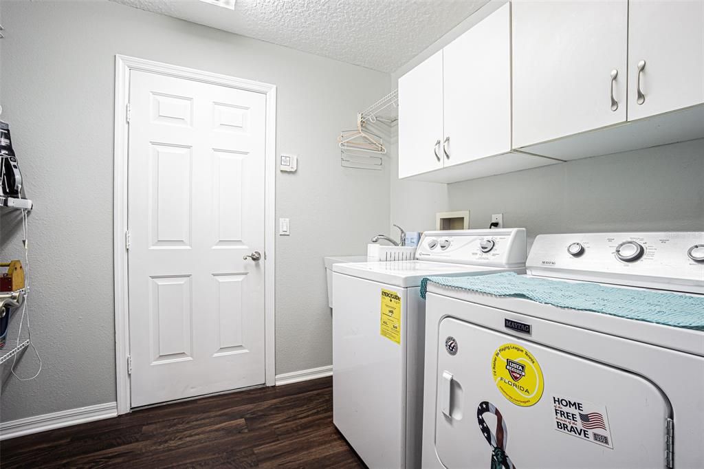 LARGE Laundry Room with extra shelving for storage and a utility sink